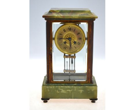 A late 19th century onyx mounted lacquered brass four window mantel clock, the eight-day two train movement numbered 2996/58 