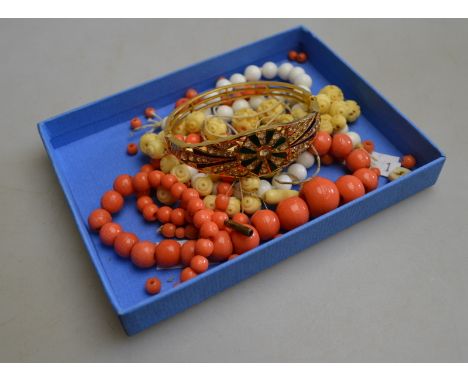 An Indian yellow metal enamelled bangle set with white pastes and enamel, approx 20 g all in to/w a quantity of beads