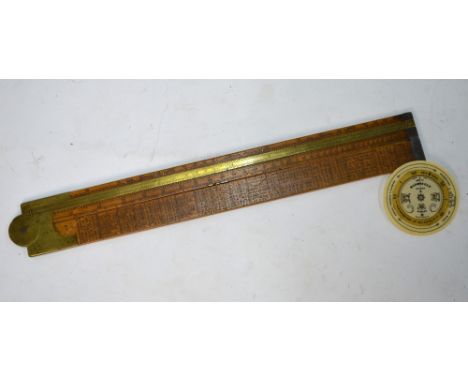 A 19th century folding boxwood carpenter's slide rule with brass hinge, slide and end-caps, printed with stress and load tabl