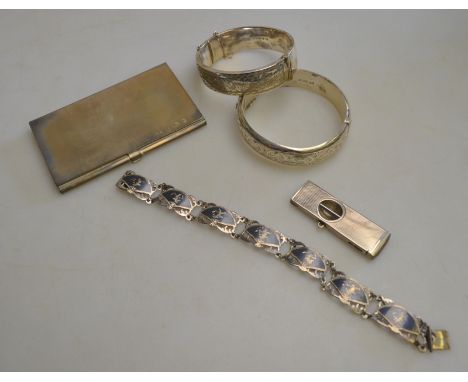 A lot containing two half engraved silver bangles, Siamese niello bracelet, silver cigar cutter, and silver card case, approx