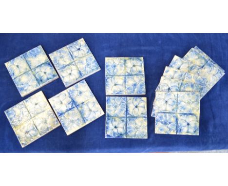 A set of Eleven, English glazed tiles; each one with a floral design in mottled blue, yellow and green glaze, about 15.5 cm. 