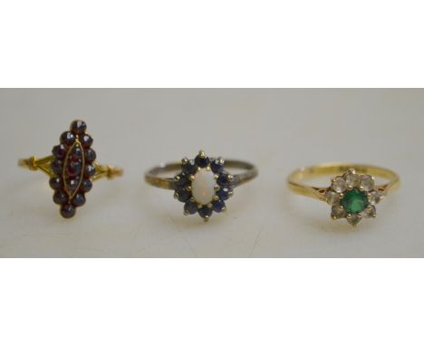 A collection of three 9ct cluster rings, one set with garnet, one set with sapphire and opal, and one set with green and whit