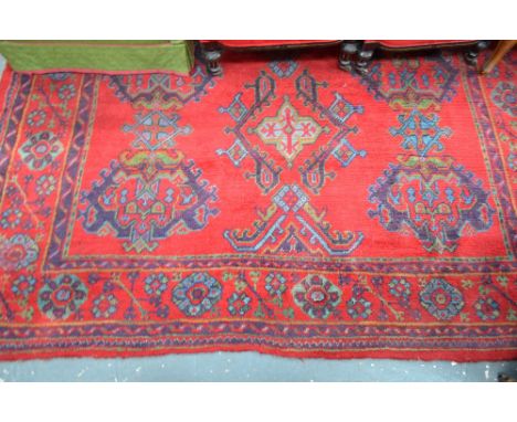 An old red ground Turkey carpet with repeating geometric design, 202 x 200 cm