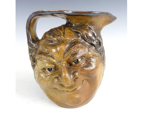 Robert Wallace Martin (1843-1923) for Martin Brothers - a stoneware 'Face' jug (1914), each side modelled with a grotesque sm