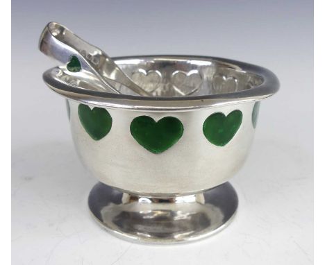 An Art Nouveau silver pedestal footed sugar bowl, the folded top rim over green inset heart shaped enamel repeating decoratio