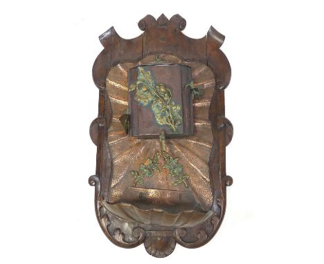 A French Art Nouveau copper and brass wall mounted water fountain, applied onto shaped oak backboard, the fountain with remov