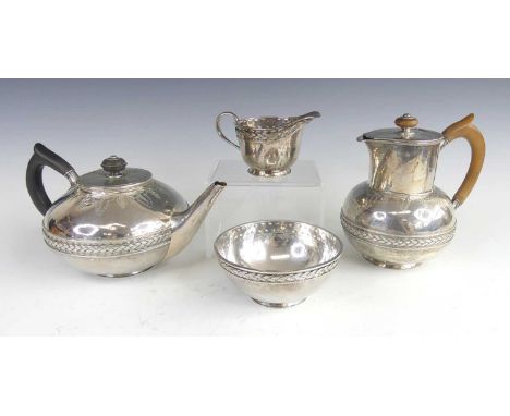 A late Arts &amp; Crafts silver four piece tea and coffee set, comprising; teapot, coffee pot, sugar bowl and a cream jug, ea