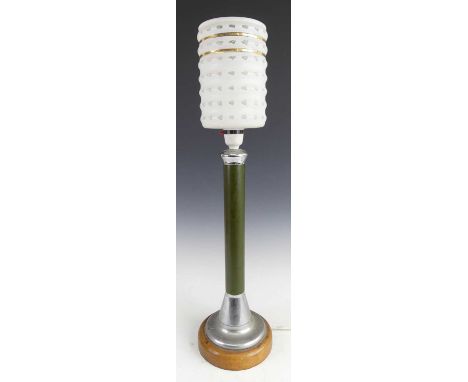 A 1960s spun aluminium and laminate table lamp, of plain turned form, raised on teak integral circular base, with frosted rib