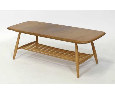 A 1960s Ercol blond elm and beech 'Windsor' coffee table, the top with rounded corners, raised on turned supports with ladder