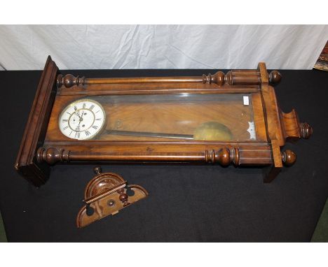 Early 20th Century Vienna wall clock, the walnut case with arched pediment, the glazed door flanked by half-turned pilasters,