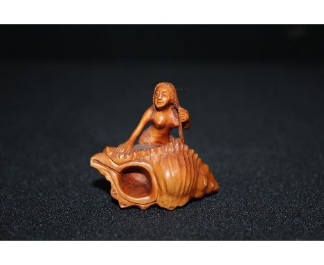 Japanese carved wooden netsuke depicting a mermaid on a shell, signed to the base