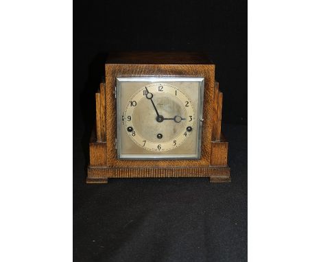Clarion Art Deco oak mantle clock, with stepped case, the silvered dial with Arabic numerals and strike/silent switch for the
