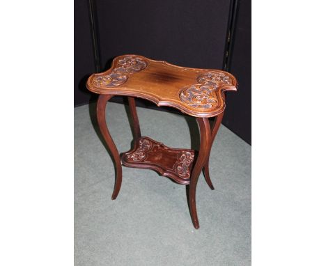 Early 20th Century mahogany centre table, the rectangular top with acanthus leaf carved ends above slender legs untied by a s