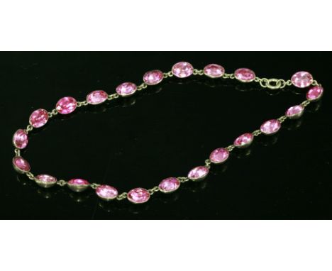 A Georgian silver, pink paste set rivière, c.1800-1820,the necklace composed of a series of foiled, oval faceted, pink paste,