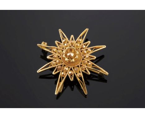 An Indian gold India star brooch/pendant,with twisted wire, faceted gold bead and diamond cut decoration to a concealed bale 