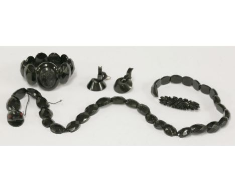 A Victorian jet snake necklace,  HBwith graduated, faceted oval cabochons forming the body, carved and faceted head with red 