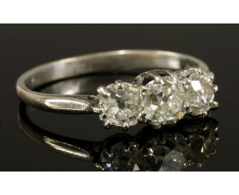 A three stone diamond ring,with three graduated cushion cut diamonds, with an estimated total diamond weight of approximately