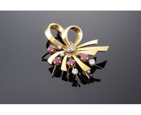 A two-colour gold, ruby and diamond spray brooch, c.1950,with a polished gold ribbon bow.  A white loop to the centre, grain 