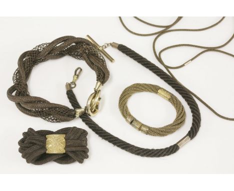 A Victorian woven hair memorial bracelet,  HBwith four rows of woven and plaited dark brown hair, gathered with a gold scallo
