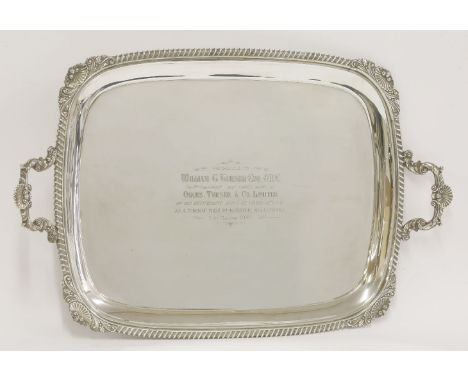 A silver two-handled tray,by Harrison Brothers & Howson, Sheffield 1939,of oblong form with shell leafy scroll and gadroon bo