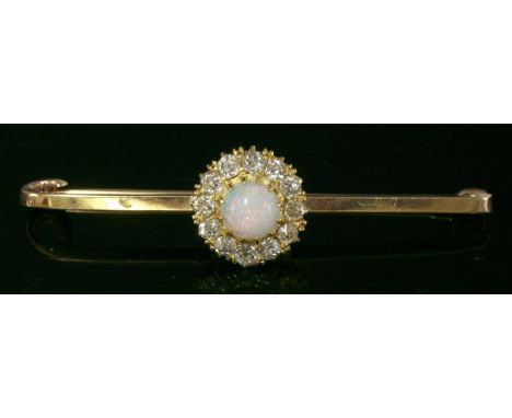 An opal and diamond cluster bar brooch,with a circular cabochon opal, claw set to the centre, surrounded by old, Swiss cut di