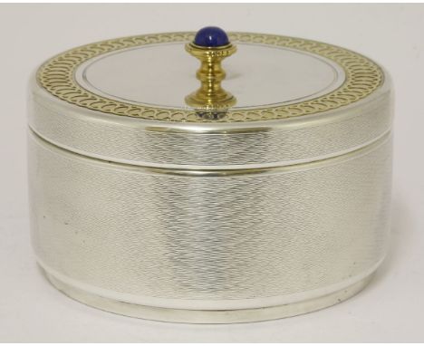 An unusual large box,by Garrard & Co. Ltd., London 1993,of engine turned circular form, the pull-off cover with silver gilt g