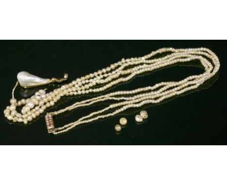 A two-row graduated natural pearl necklace,with a blister pearl, ruby and diamond pendant.  The graduated natural pearls, 335