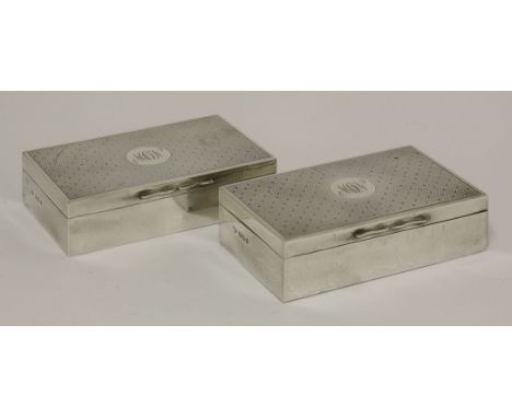 A pair of silver boxes,by Finnigans Ltd., London 1919,of rectangular form, the covers engraved with rayed engine turning and 