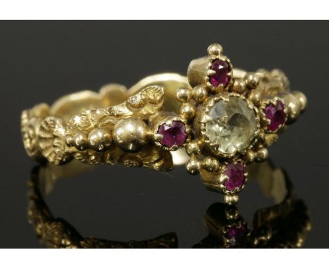 A William IV gold, chrysolite and ruby cluster ring, c.1835,with a central Swiss cut chrysolite with an oval faceted ruby at 