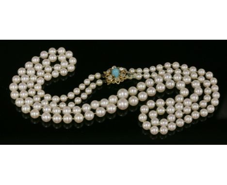 A two-row graduated cultured pearl necklace,with a turquoise and diamond cluster gold box clasp.  Two rows of graduated cultu
