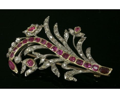 A Portuguese ruby and diamond spray brooch, c.1750,with a central line of graduated cushion-shaped rubies set in gold.  A spr