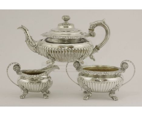 A Victorian silver teapot,by David Crichton Rait, Edinburgh 1841,of half fluted circular form on four leaf capped paw feet, w