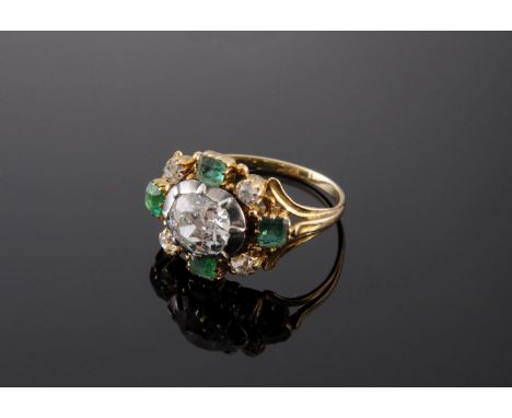 A Georgian diamond and emerald cluster ring,with an old European cut diamond, estimated as approximately 1.00ct, in a silver 