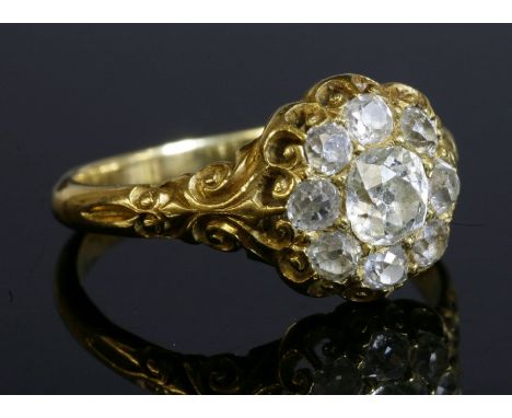 A late Victorian diamond set cluster ring,with a central cushion cut diamond, surrounded by old European cut diamonds.  All c