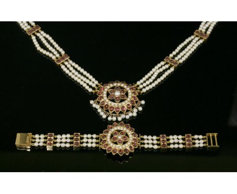 An Indian high carat gold cultured pearl and garnet, three row cultured pearl necklace and bracelet suite.The necklace with a
