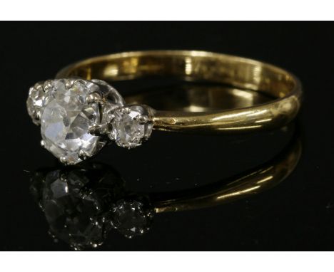 A single stone diamond ring,with diamond set shoulders, with a cushion cut diamond, estimated as approximately 1.18ct, and an