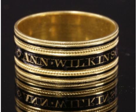 A Regency gold memorial ring,  HBwith a central black champlevé enamel band with memorial to read 'Ann. Wilkinson. OB:22 Mar: