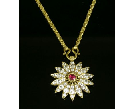 An Indian high carat gold, synthetic ruby and synthetic white sapphire flower head pendant,with a circular Swiss cut syntheti