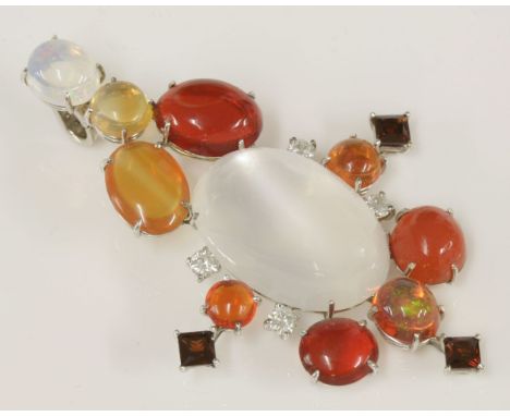 A white gold, moonstone, opal, garnet and diamond pendant,with a diamond set hinged bale.  An oval cabochon moonstone, claw s