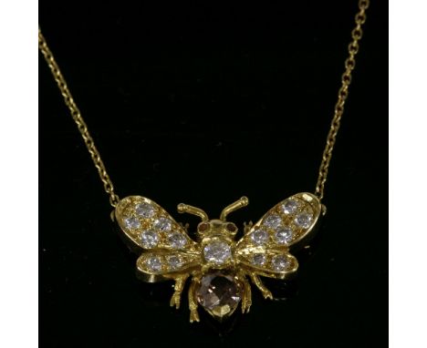 An 18ct gold diamond set butterfly pendant,with an old European cut diamond set to form the abdomen, possibly fancy light bro