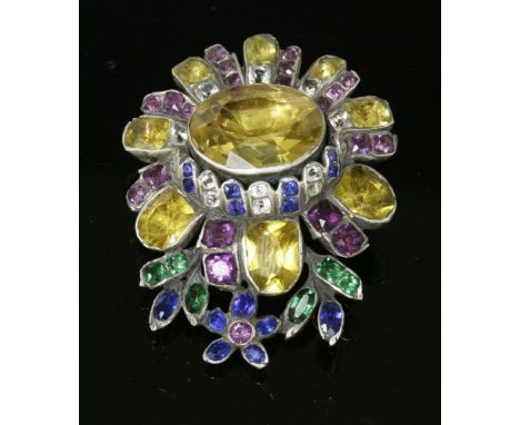 A Georgian polychrome paste set flower head brooch,with a foiled yellow oval paste, rub set to the centre.  Graduated, lobed 