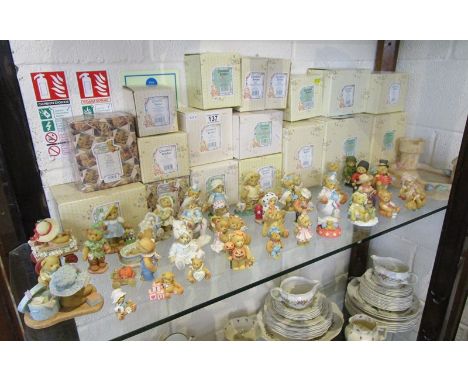 Shelf of approx 57 'Cherished Teddies' to include many boxed examples and sand castle