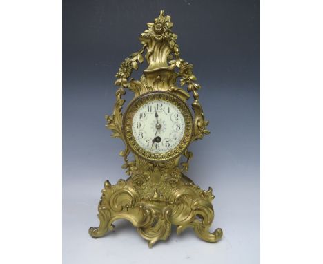 A CAST BRASS ROCOCO TIME PIECE IN THE LOUIS XV STYLE, the enamel dial with steel spade hands and French single train barrel m