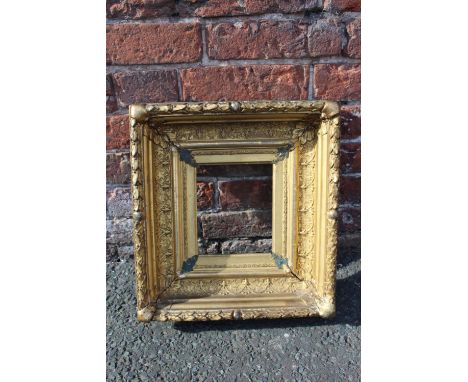 AN 18TH CENTURY CONTINENTAL DECORATIVE GOLD FRAME, with acanthus leaf design to outer edge, frame W 12 cm, rebate 21 x 18 m