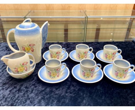 Susie Cooper Coffee Set, elephant shaped coffee pot in cream base with floral decoration and blue handle and lid, with six co