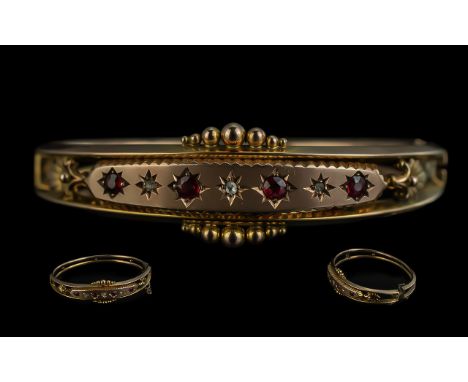 Edwardian Period 1901 - 1910 Attractive 9ct Gold Hinged Bangle set with rubies and diamonds, fully hallmarked for 9ct, of exc