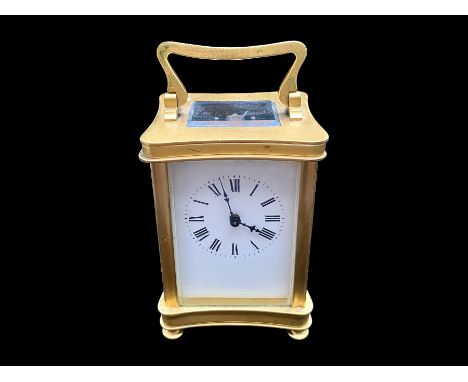 A Small Brass Carriage Clock of typical form, white enamel dial and Roman numerals. Height 4½ inches. 