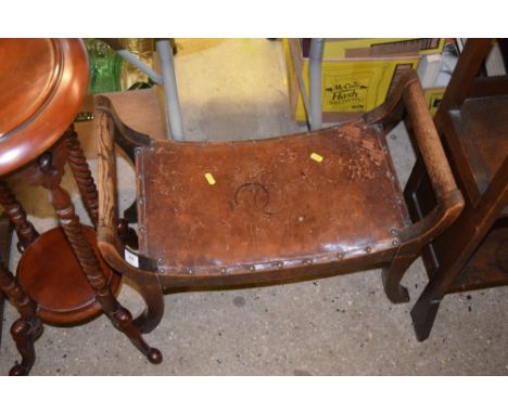 An oak framed leather seated stool 