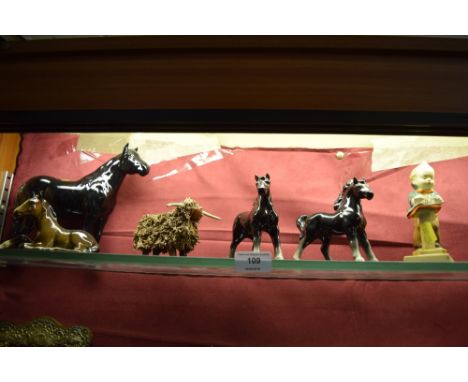 A Beswick model of a recumbent horse; another Beswick model horse; two foreign model horses; a model cow; and a Goebel style 