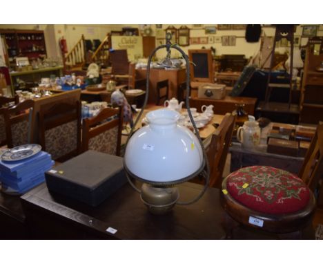 A brass hanging oil lamp with opaque glass shade 
